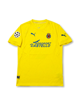Front view of Villarreal 2005-06 Champions League home shirt with yellow body, club crest, Aeroport Castello sponsor, and UEFA Champions League sleeve patch.