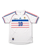 Front view of France 1998 World Cup away shirt with white body, blue and red chest stripes, FFF crest, and #10 front number.