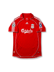 Front view of Liverpool 2005-06 Champions League home shirt with red body, Carlsberg sponsor, club crest, Adidas detailing, and European sleeve patches.