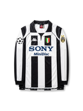 Front view of Juventus 1997-98 Champions League home long sleeve shirt with black and white stripes, Sony MiniDisc sponsor, Juventus crest, Scudetto shield, and UEFA sleeve patch.