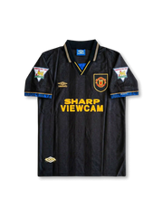 Front view of Manchester United 1993-95 away shirt with black striped body, Sharp Viewcam sponsor, club crest, Umbro logo, and champion sleeve patches.