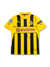 Front view of Borussia Dortmund 2012-13 Champions League home shirt with yellow and black stripes, Evonik sponsor, BVB crest, and European sleeve patches.