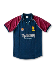 Front view of West Ham United Iron Maiden Brave New World special edition shirt with dark teal body, claret sleeves, Maiden branding, Eddie graphic, and club crest.