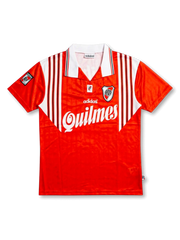 Front view of River Plate 1995-96 away shirt with red body, white shoulder striping, Quilmes sponsor, club crest, and Adidas detailing.