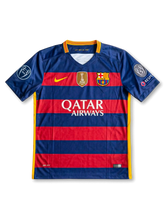 Front view of Barcelona 2015-16 Champions League home shirt with red and blue horizontal stripes, Qatar Airways sponsor, club crest, FIFA badge, and European sleeve patches.