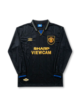 Front view of Manchester United 1994-96 black away shirt with long sleeves, Sharp Viewcam sponsor, club crest, gold detailing, and fold-over collar.