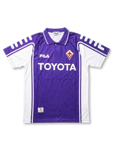 Front view of Fiorentina 1999-00 home shirt with purple body, white side panels, Toyota sponsor, and club crest.
