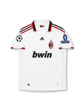 Front view of AC Milan 2009-10 away shirt with white body, red-and-black trim, bwin sponsor, club crest, and Champions League sleeve patches.