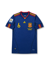 Front view of Spain 2010 World Cup Final away shirt with navy body, Spain crest, #6 chest number, South Africa 2010 sleeve patch, and Netherlands-Spain final embroidery.