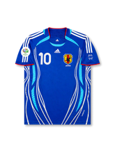 Front view of Japan 2006 World Cup home shirt with blue body, Japan crest, #10 chest number, Germany 2006 tournament patch, and white side graphics.
