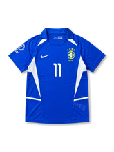 Front view of Brazil 2002 World Cup away shirt with blue body, white side panels, Brazil crest, #11 chest number, and Korea/Japan 2002 sleeve detail.
