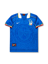 Front view of Italy 1995-96 home shirt with blue tonal geometric pattern, large subtle crest graphic, white collar, tricolor sleeve trim, and Italy crest.