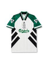 Front view of Liverpool 1993-95 away shirt with white body, green sleeves, black diagonal graphics, Carlsberg sponsor, club crest, and Premier League sleeve patches.