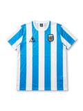 Front view of Argentina 1986 World Cup home shirt with sky-blue-and-white vertical stripes, Argentina crest, chest logo, and classic crew-neck collar.