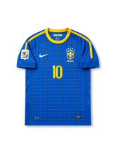 Front view of Brazil 2010 World Cup away shirt with blue body, yellow collar trim, Brazil crest, #10 chest number, dotted front graphic, and South Africa 2010 sleeve patch.