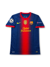 Front view of Barcelona 2011-12 home Authentic (Player Issue) shirt with navy body, red center stripe, Qatar Foundation sponsor, Barcelona crest, FIFA Club World Champions badge, and Champions League sleeve patches.