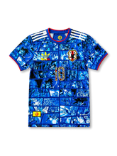 Front view of Japan × Dragon Ball special edition shirt with blue manga panel graphics, Japan crest, Dragon Ball detail, white shoulder stripes, and #10 illustrated chest number.