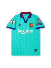 Front view of Barcelona 2019-20 third shirt with turquoise body, Rakuten sponsor, Barcelona crest, navy and maroon collar trim, and UEFA Champions League sleeve patches.