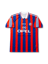 Front view of Bayern Munich 1995-97 home jersey with red and blue vertical stripes, OPEL sponsor, white collar, and club crest.