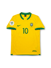 Front view of Brazil 2006 home jersey with yellow body, green trim, CBF crest, #10 front print, and Germany 2006 sleeve patch.