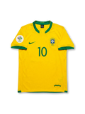 Front view of Brazil 2006 home jersey with yellow body, green trim, CBF crest, #10 front print, and Germany 2006 sleeve patch.