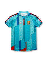 Front view of Barcelona 1996-97 away jersey in turquoise with geometric red and blue design, club crest, Kappa logo, and collar detail.