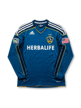 Front view of LA Galaxy 2007-08 away jersey in teal long sleeve design with Herbalife sponsor, MLS patch, U.S. flag patch, and club crest.