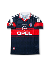 Front view of Bayern Munich 1997-99 away shirt with dark navy and red design, club crest, sponsor logo, and Champions League sleeve patch.