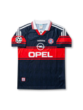 Front view of Bayern Munich 1997-99 away shirt with dark navy and red design, club crest, sponsor logo, and Champions League sleeve patch.