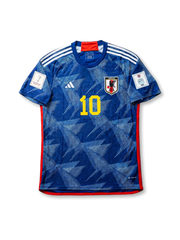Front view of Japan 2022 World Cup home shirt with blue origami-inspired pattern, Japan crest, yellow #10 print, red trim, and Qatar 2022 sleeve patch.
