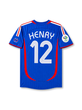 Back view of France 2006 World Cup home shirt with Henry name and #12 printing, red curved side panels, royal blue base, and Germany 2006 sleeve patch.