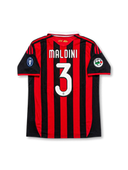 Back view of AC Milan Maldini #3 legacy edition shirt with Maldini name and #3 printing, red and black striped design, gold AC Milan neck detail, and sleeve patches.