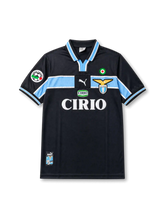 Front view of Lazio 2000-01 away shirt with dark navy-black base, sky blue chest band, Lazio crest, CIRIO sponsor, Scudetto badge, and Lega Calcio sleeve patch.