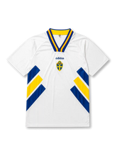 front view of Sweden 1994 World Cup away shirt with white base, blue and yellow diagonal side graphics, V-neck collar, and Sweden crest