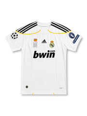 front view of Real Madrid 2009-10 home shirt with white base, bwin sponsor, club crest, yellow trim, Champions League patch, and UEFA Respect sleeve patch