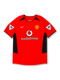 front view of Manchester United 2002-04 home shirt with red base, black side panels, Vodafone sponsor, club crest, and Premier League sleeve patches