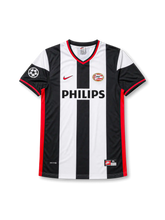 front view of PSV Eindhoven 1998-00 away shirt with black and white stripes, Philips sponsor, PSV crest, red trim, and Champions League sleeve patch