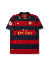 front view of Arsenal 2007-08 away shirt with red and navy hoops, Fly Emirates sponsor, Arsenal crest, gold Nike logo, and Champions League sleeve patch