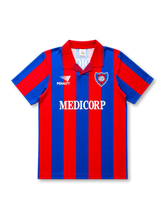 front view of San Lorenzo 1994 home shirt with red and blue vertical stripes, Medicorp sponsor, Penalty branding, club crest, and red collar
