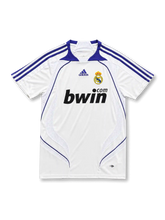 front view of Real Madrid 2007-08 home shirt with white body, purple adidas stripes, bwin sponsor, club crest, and ClimaCool detailing