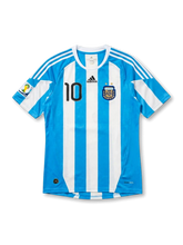 front view of Argentina 2010 World Cup home shirt with sky blue and white stripes, black number 10, Argentina crest, adidas logo, and South Africa 2010 sleeve patch