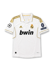 front view of Real Madrid 2011-12 home shirt with white body, gold adidas stripes, bwin sponsor, club crest, Champions League patch, and UEFA Respect sleeve patch