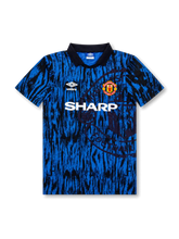 front view of Manchester United 1992-94 third shirt with blue and black abstract graphics, Sharp sponsor, Umbro logo, club crest, and black polo collar