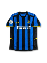 front view of Inter Milan 2002-03 home shirt with blue and black stripes, Pirelli sponsor, Inter crest, Nike logo, yellow trim, and Serie A sleeve patch