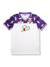 front view of Fiorentina 1992-93 away shirt with white body, purple shoulder graphics, 7UP sponsor, Lotto branding, and Fiorentina crest