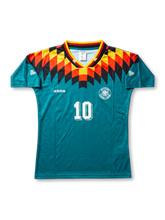 front view of Germany 1994 World Cup away shirt with teal body, black red and yellow shoulder graphics, adidas logo, Germany crest, and front number 10