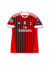 front view of AC Milan 2011-12 home shirt with red and black stripes, Fly Emirates sponsor, Scudetto shield, club crest, Champions League patch, and UEFA Respect patch
