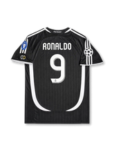 back view of Real Madrid 2006-07 away shirt with Ronaldo name, white number 9, black body, white curved side paneling, and Champions League sleeve patch