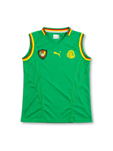 Cameroon 2002 home sleeveless jersey, front view, green with red and yellow ribbed V-neck and armhole trim, federation crest, yellow Puma logo, yellow lion head emblem