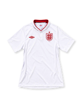 England 2012 home jersey, front view, white with red-trimmed shawl collar, single-button placket, red Umbro logo, red Three Lions crest with star